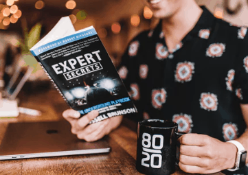 Entrepreneur reading expert secrets book